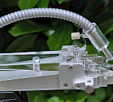 PAM-2500 accessory for field measurements: Light and temperature-sensing leaf clip (type 2030-B) on tripod.