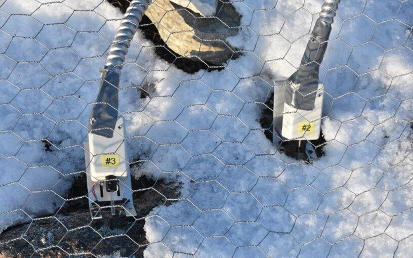 MICRO-PAM prototype installed near CHARS (Canadian High Arctic Research Station) Cambridge Bay, Nunavut; note the protection by wire mesh over the MICRO-PAMs and steel conduit over the cable, this is necessary protection against inquisitive local animals (lemmings, foxes and bears).